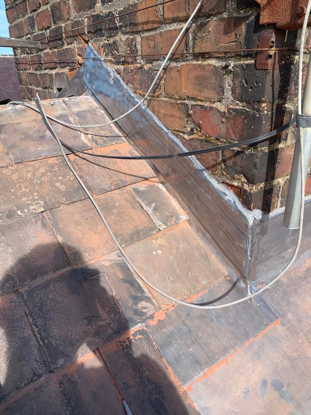 Lead flashing repair around a chimney stack